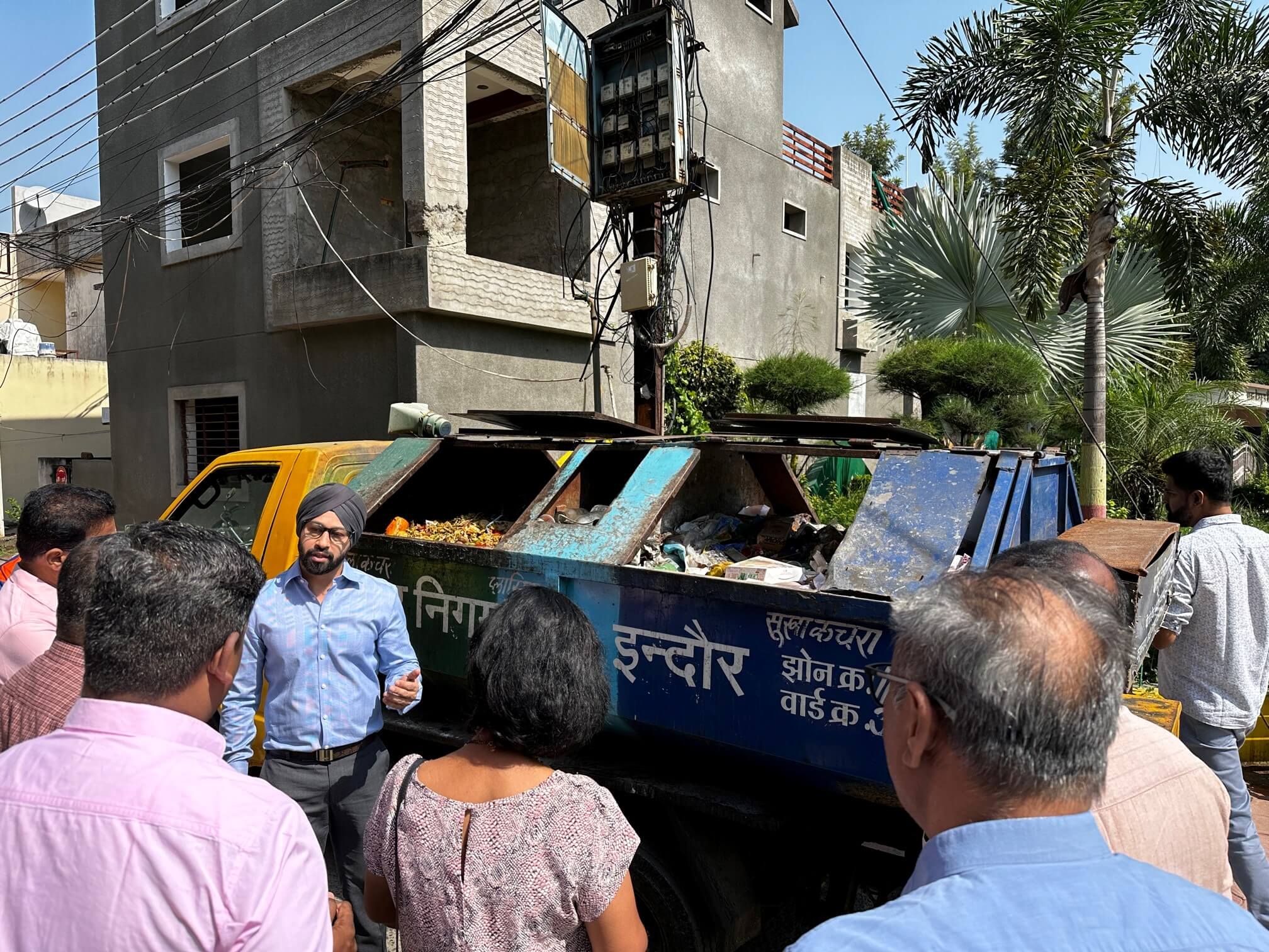 Study tour participants learn about the city's source-separated waste collection vehicles in Indore, India. <br><span class='small text-muted'>(2023, Indore, India)</span>